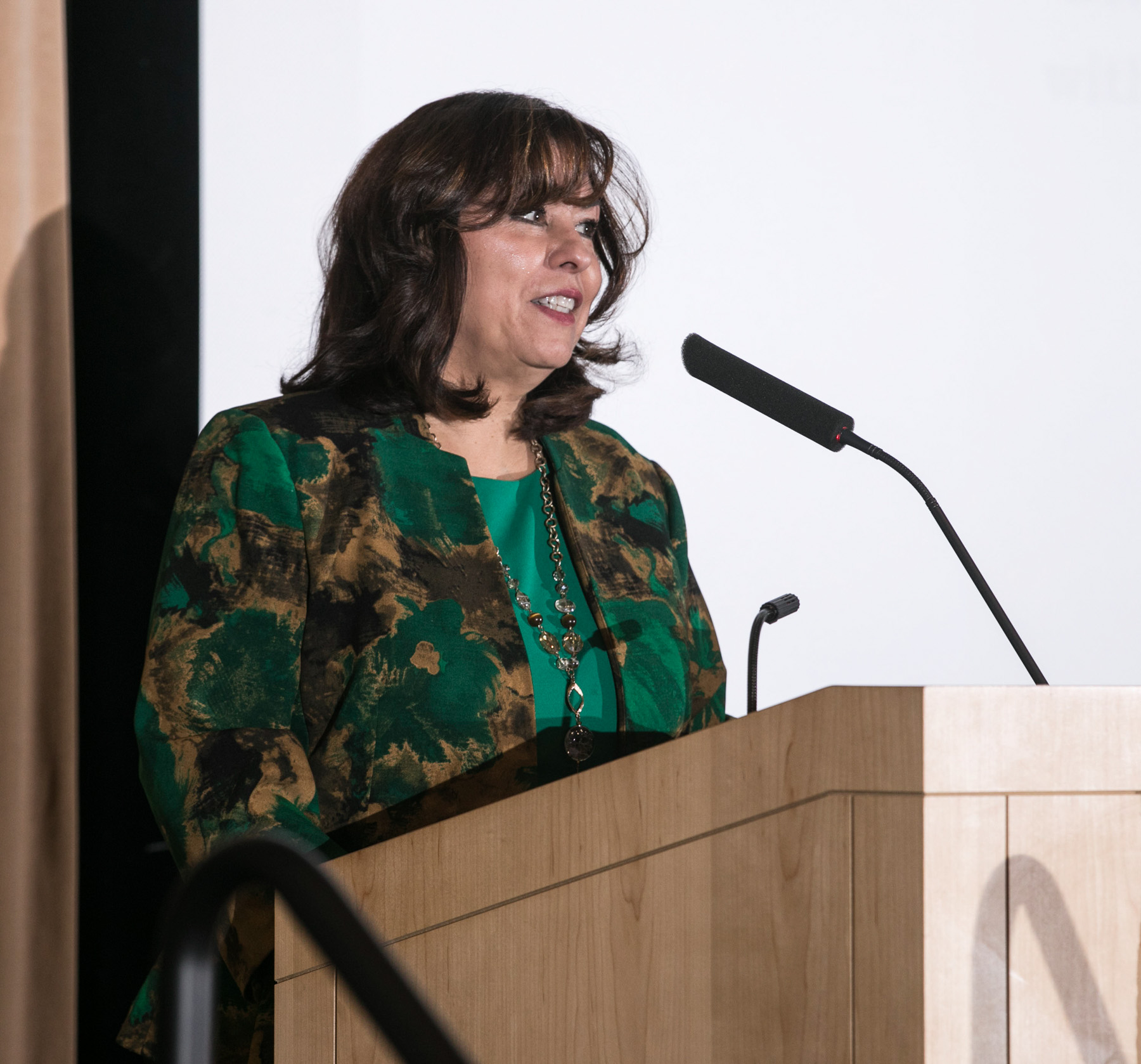 Elizabeth Ortiz, vice president of the Office of Institutional Diversity and Equity, welcomes members of the university community as they gather at the Lincoln Park Student Center to honor Latina activist Dolores Huerta. (DePaul University/Jamie Moncrief)